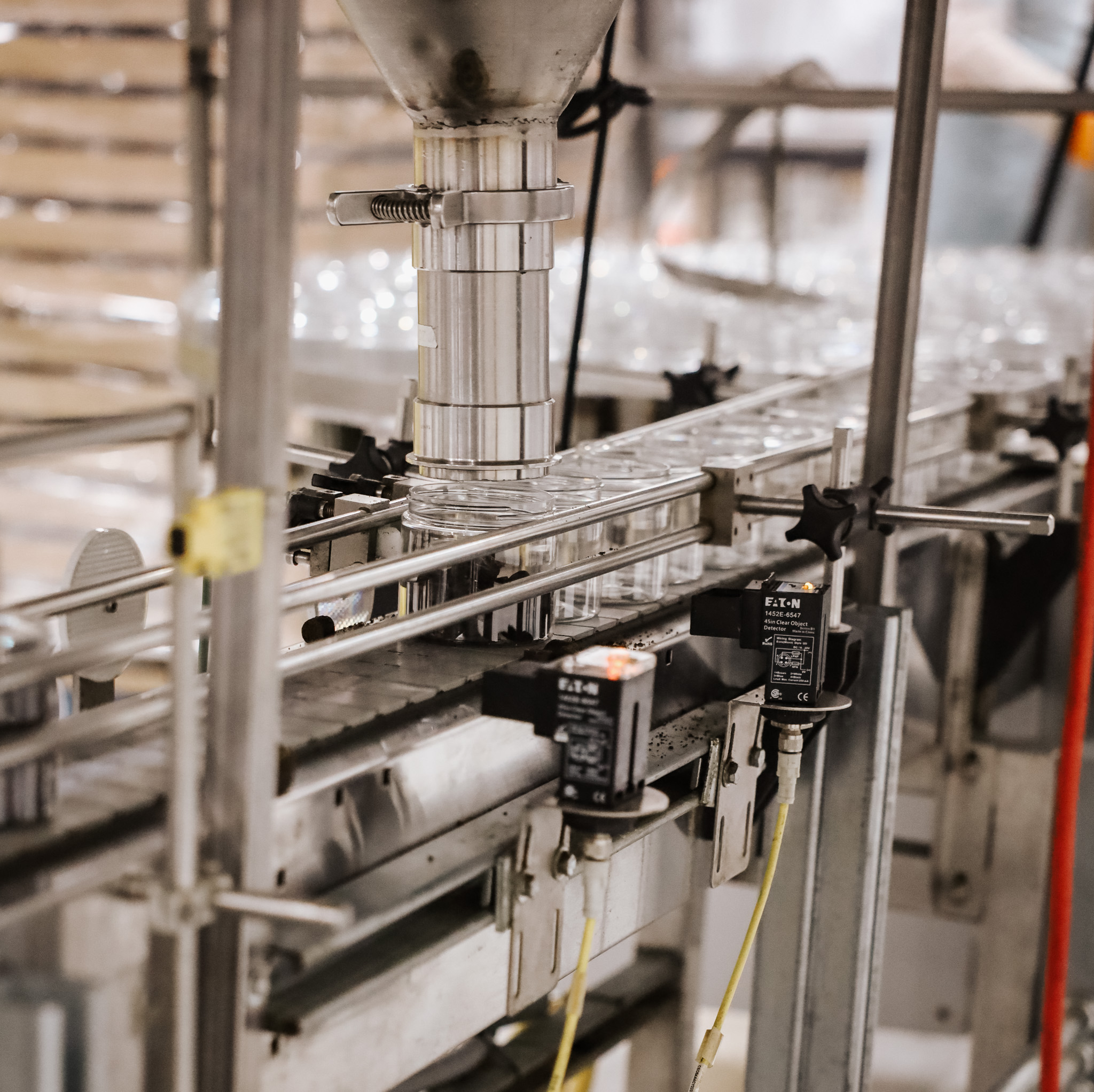 Close up of the machinery pouring canine supplements into the bottles