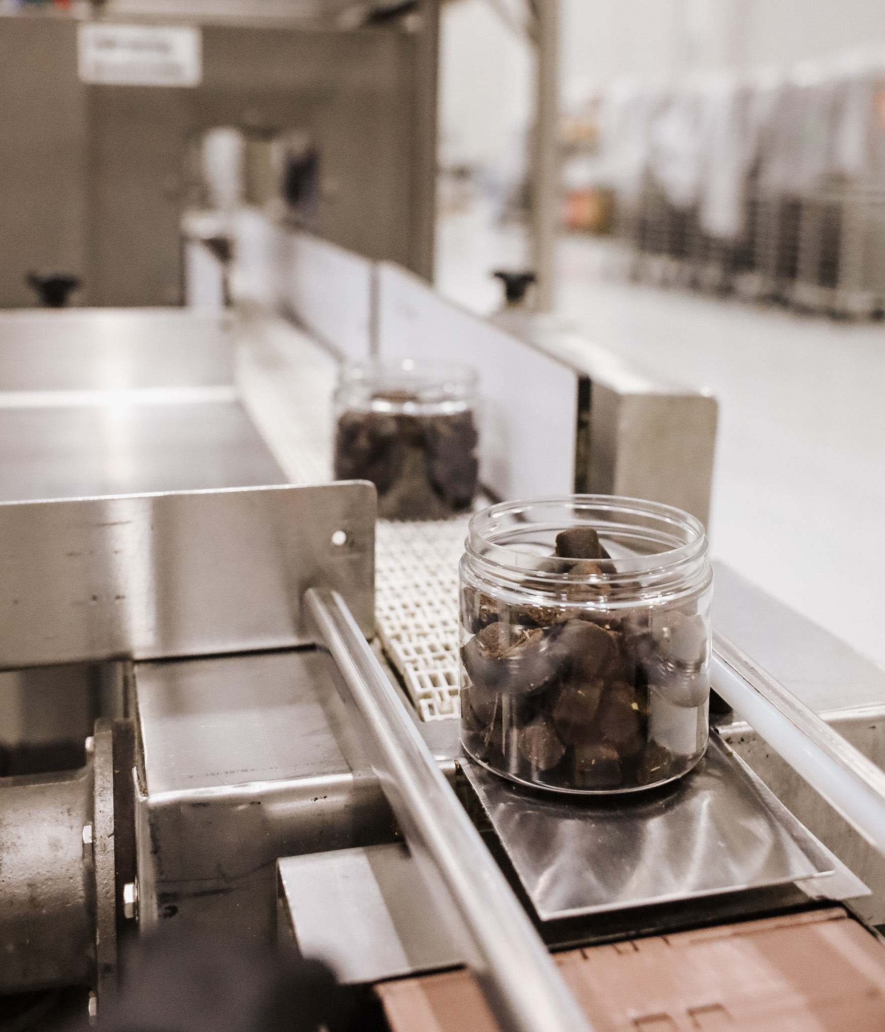 Close up of two clear bottles on the conveyor belt